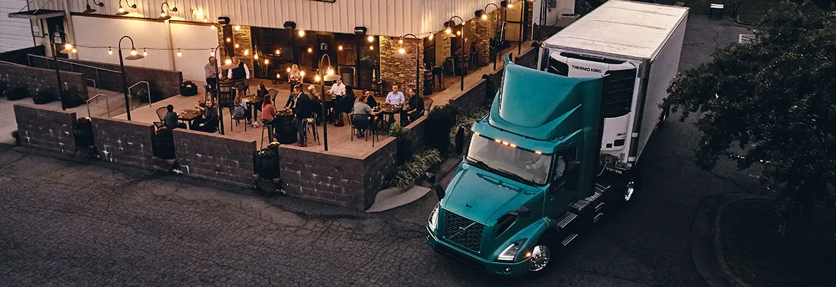 Overhead view of a VNR Electric driving near a restaurant